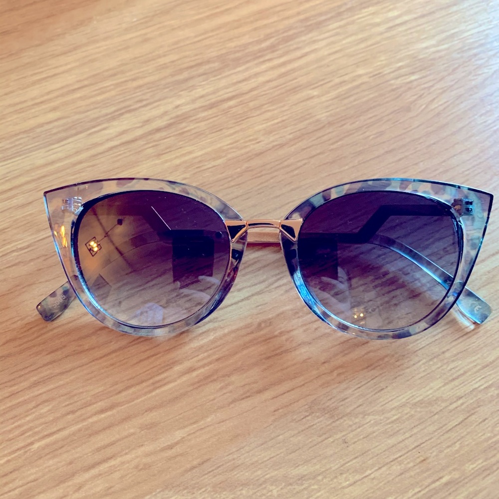 Cat shaped sunglasses. Transparent blue frames.